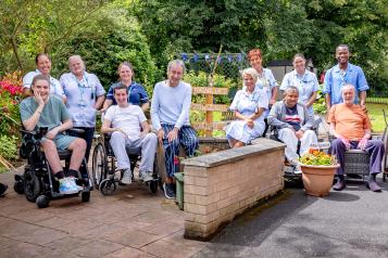 Patients and colleagues in the garden at Magnolia Lodge