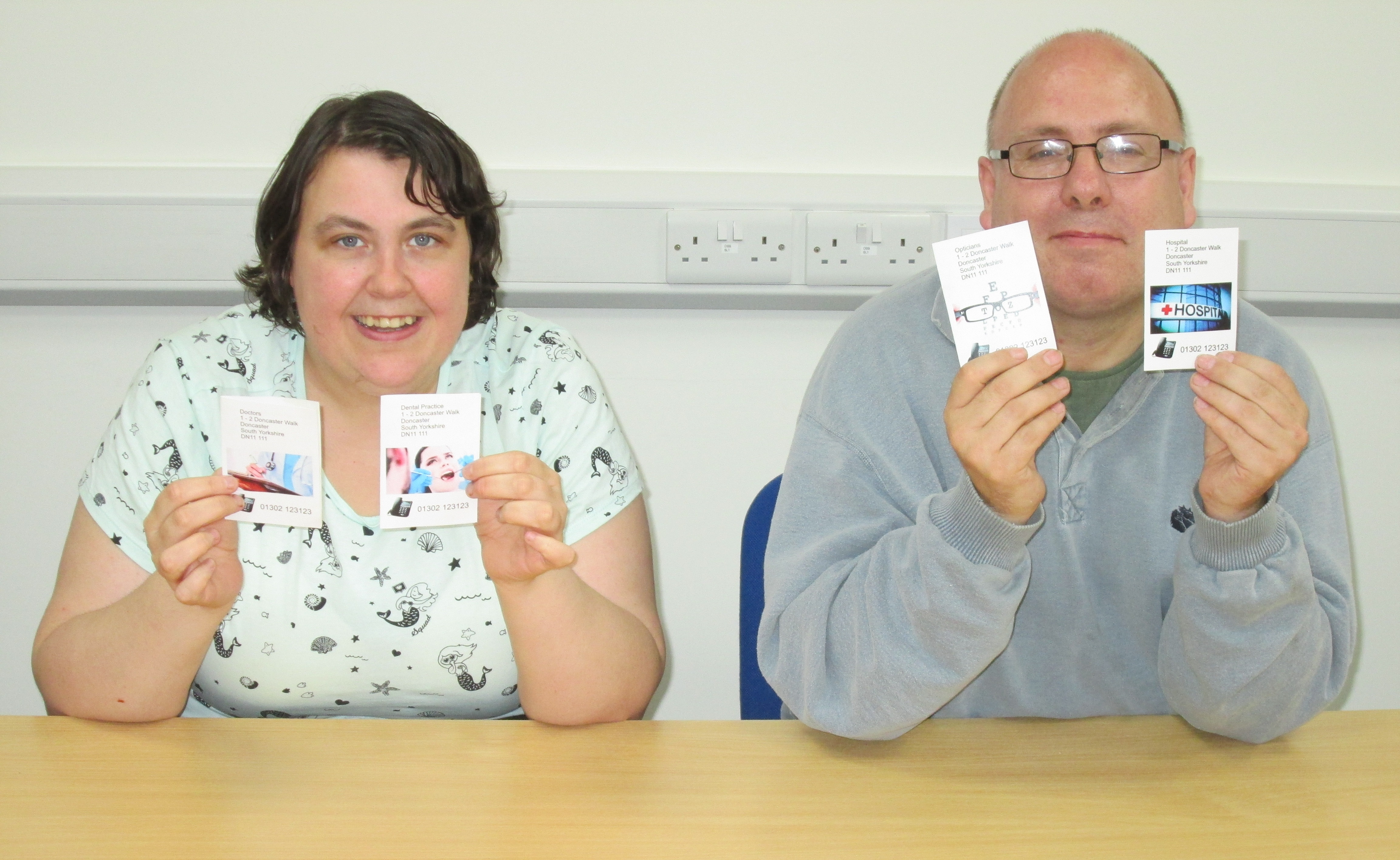 Female and male holding a card