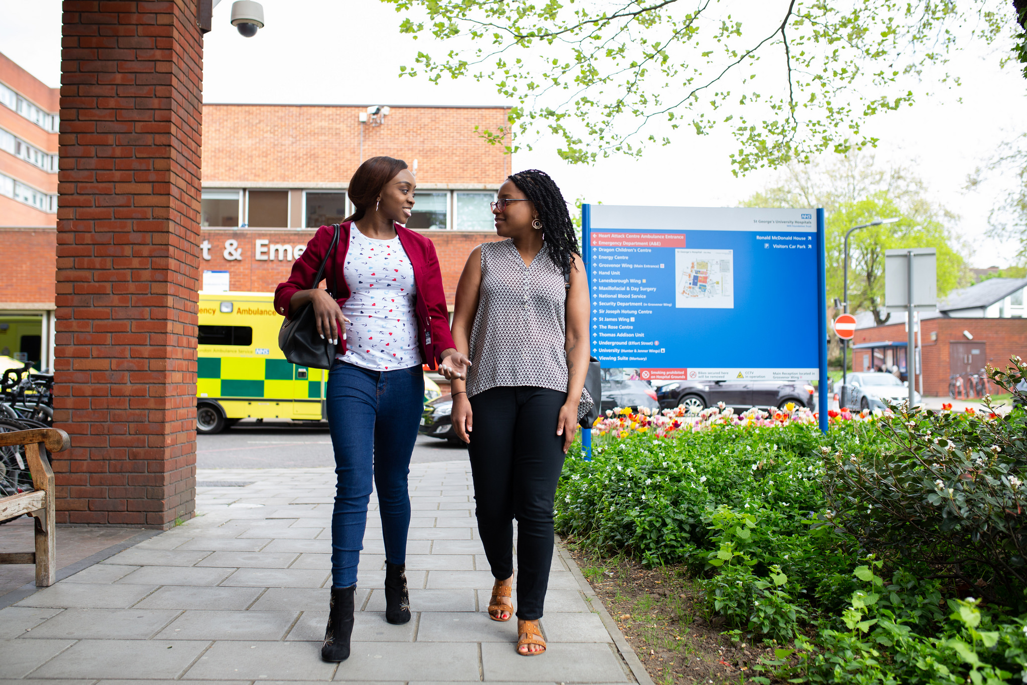 Two women outside of a hospital Two women outside of a hospital