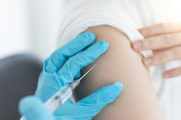 Person getting a vaccination in the arm