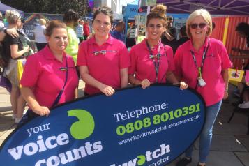 Four females stood in front of a banner that says Healthwatch Doncaster