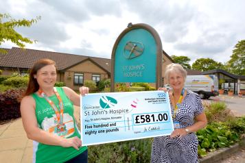 Jo handing over her cheque to Maureen at St John’s